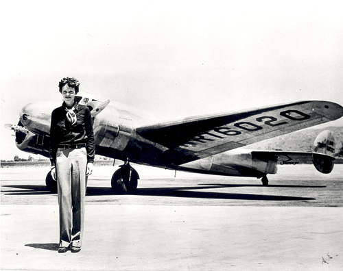 Amelia Earhart with the Lockheed Electra in which she disappeared, July 1937.
