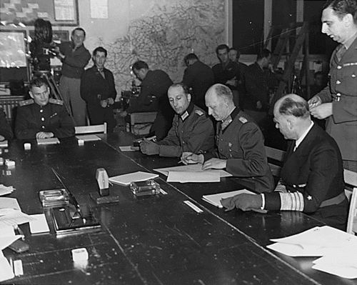 General Alfred Jodl signing the unconditional surrender documents in Reims, France.