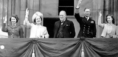 The royal family and Winston Churchill greet the crowds from Buckingham Palace. 