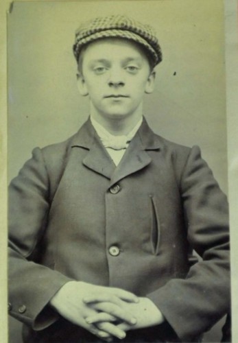 Harry Fowles, a gang member sporting the signature overcoat and peaked flat cap